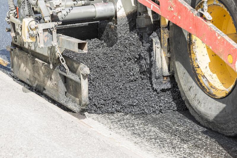 pouring black road asphalt