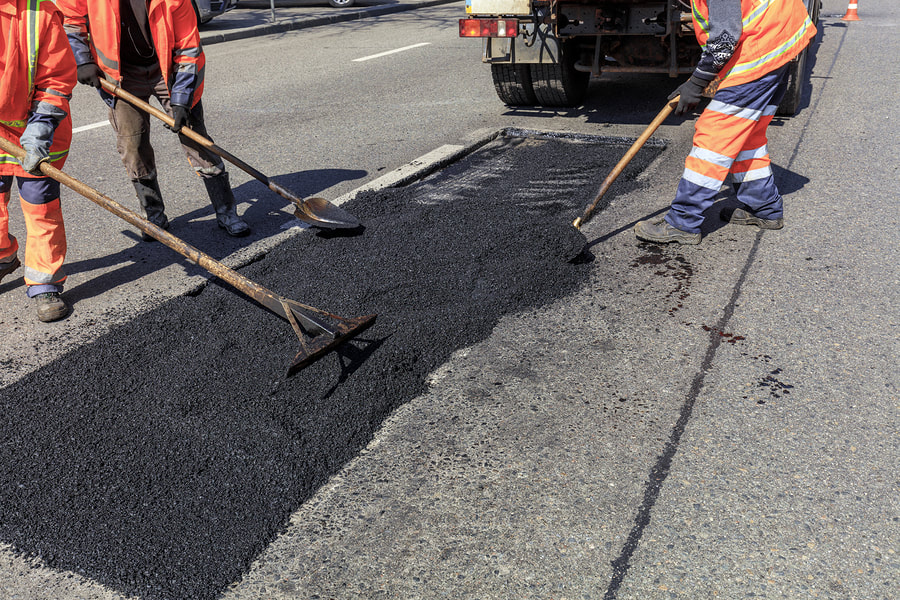 men doing asphalt repair